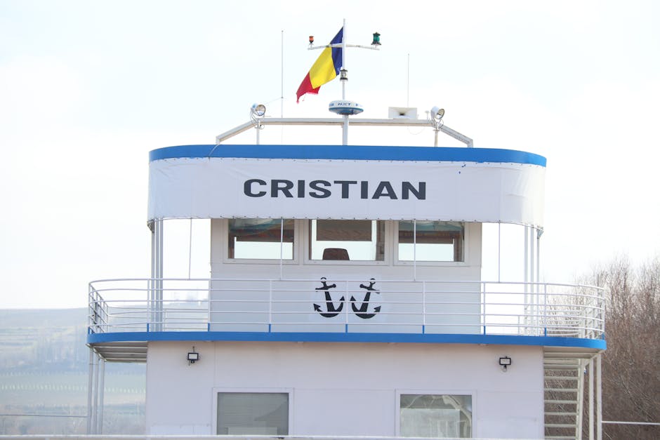 Cruise ship named Cristian with Romanian flag, anchored outdoors.