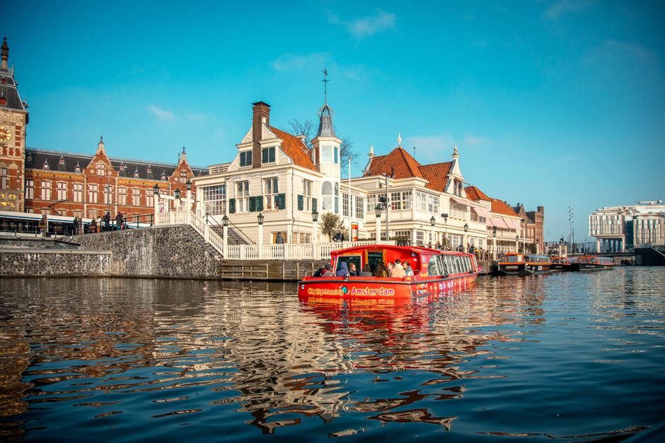 Explore Amsterdam cityscape with iconic canal and architectural charm.