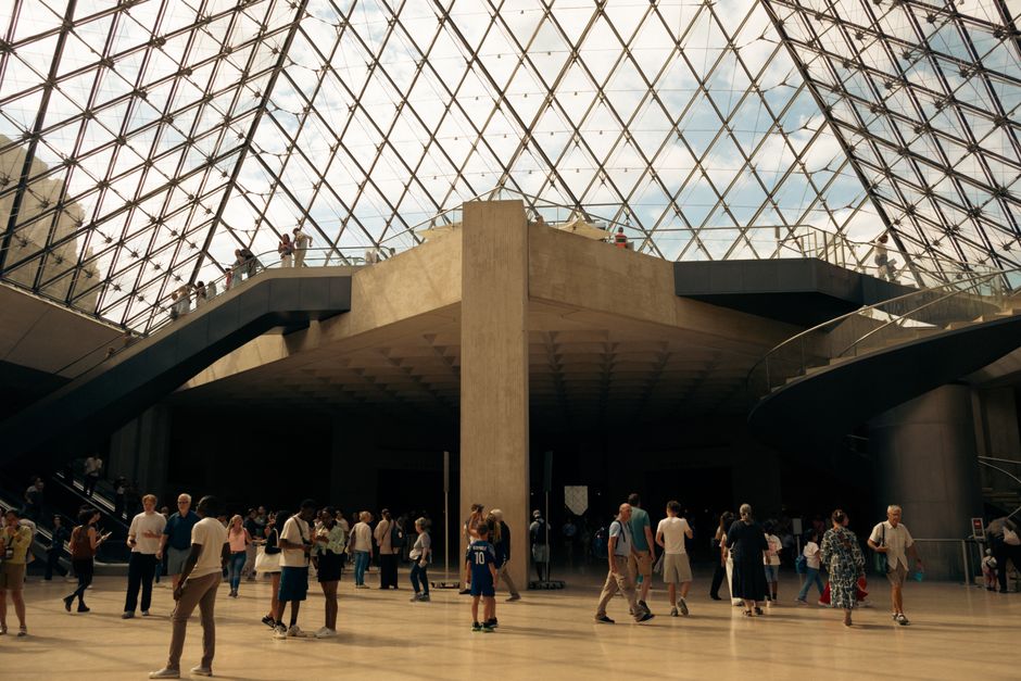 Exploring inside the iconic Louvre Pyramid, a bustling hub in Paris.