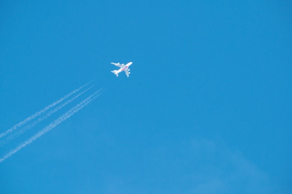 High-altitude jet crossing clear blue sky, leaving distinct contrails. Captured over Poprad, Slovakia.