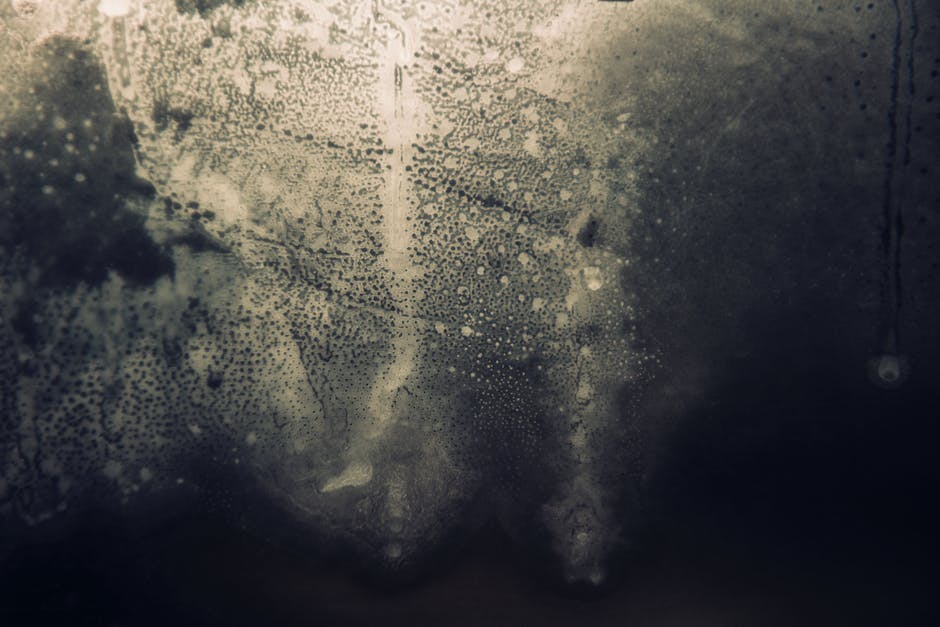 Mystical abstract close-up of fogged glass with intricate textures and vapor patterns.