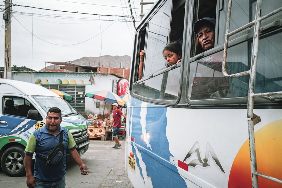 A bus scene capturing locals in Simbal, La Libertad, Peru, showcasing vibrant street life.
