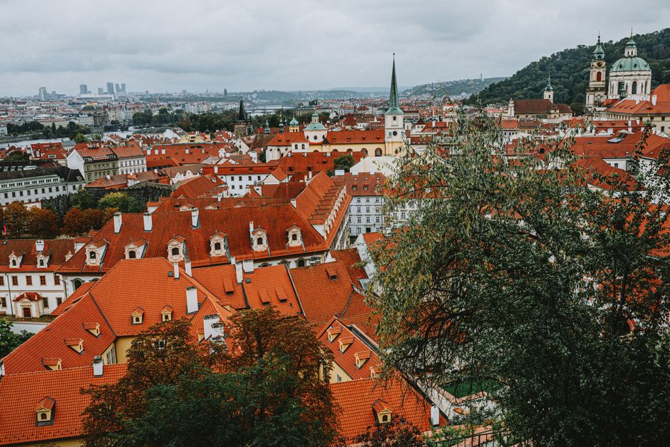 Explore the charming red rooftops of Prague, showcasing its historical architecture.