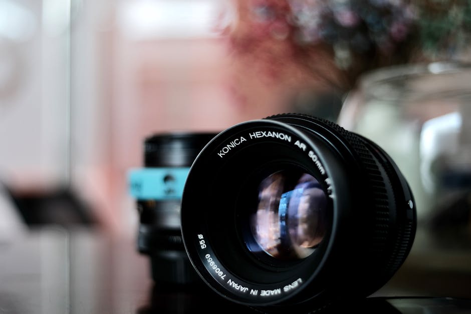 Detailed close-up of Konica Hexanon 50mm lens with blurred background.
