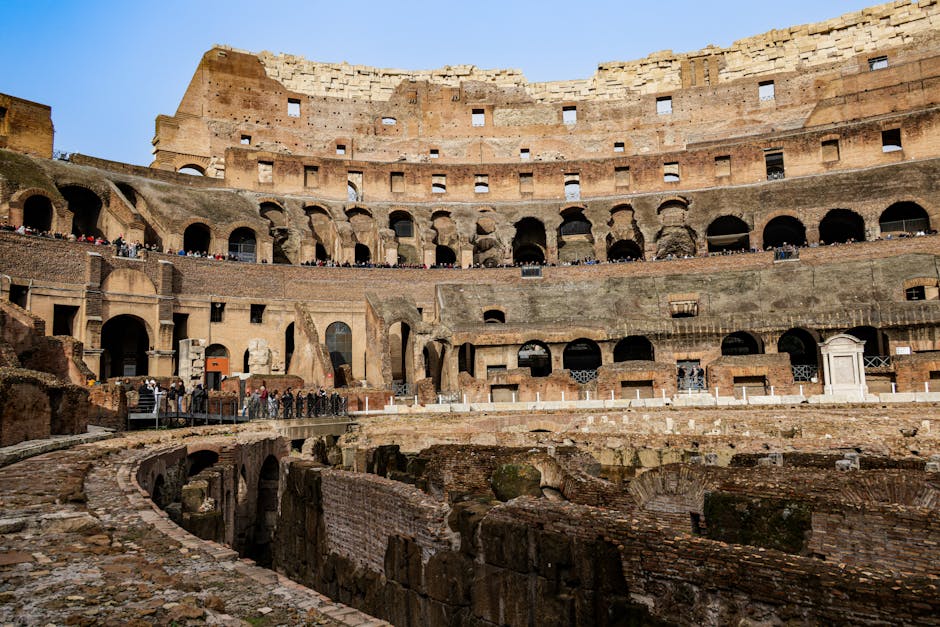 Stunning interior view of the historic Roman Colosseum, showcasing ancient architecture and stone ruins.